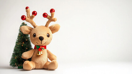 Cute plush reindeer toy with bauble antlers and a tiny Christmas tree, isolated on a white background.
