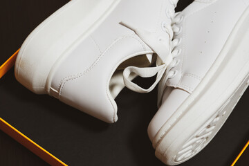 White new sneakers. dark background. Lifestyle sneaker sport shoes .