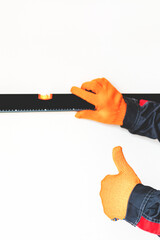 Worker's hands with bubble level.