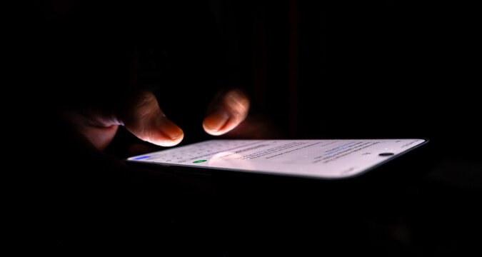 Night, cybersecurity and hands typing with phone for texting, internet troll or person cyberbullying. Dark comment, social media netizen or keyboard warrior for smartphone, online bullying or hacking