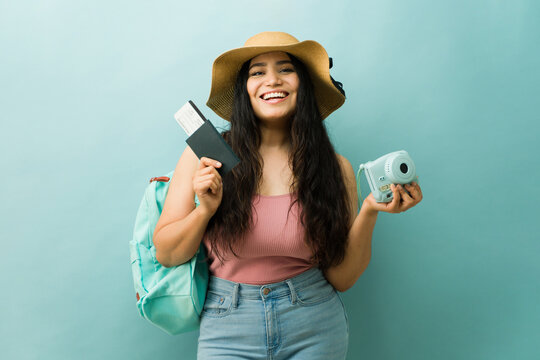 Cheerful young woman packing for summer travel vacation - Powered by Adobe