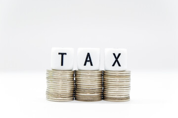 Tax Season: TAX Spelled with Dice placed in the picture of  White Surface and blurred background and foreground digitally generated image stock photo copy space