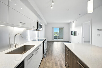 Kitchen with a sink, stove, microwave, and refrigerator
