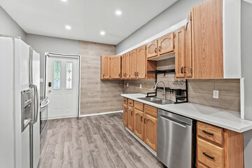 Kitchen with a stainless steel dishwasher and a silver sink