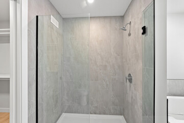 Shower stall with a glass door and a shower head