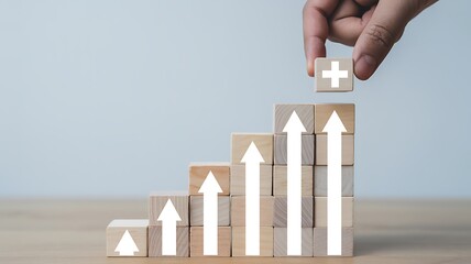Wooden blocks forming a growth chart with upward arrows and plus sign