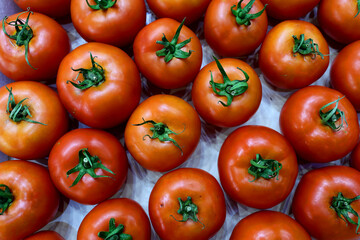 Fresh and appetizing tomato presented at an agricultural products fair. Selective focus. Photographed in natural light.