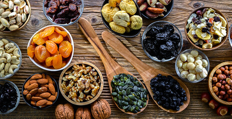 Composition with a variety of dried fruits and assorted nuts.
