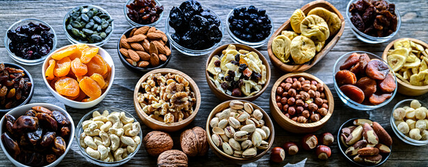Composition with a variety of dried fruits and assorted nuts.