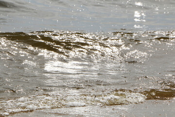 The sun's rays reflect off the surf.