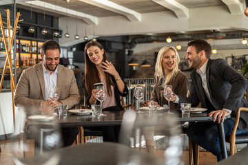 Friends enjoying a meal and conversation at a stylish restaurant