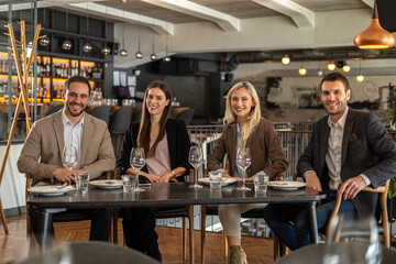 Group of friends enjoying a meal together at a stylish restaurant