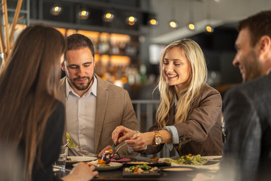 Friends enjoying a meal together at a stylish restaurant