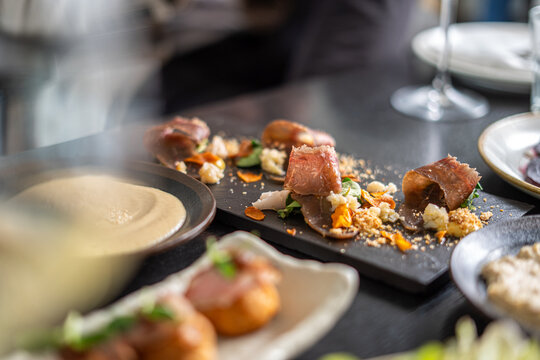 Gourmet appetizer with prosciutto and other fine dining elements