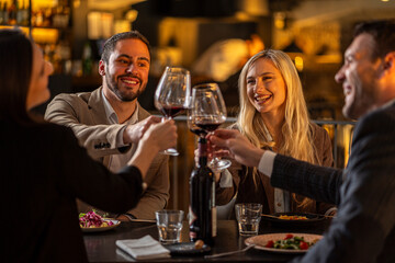 friends toasting with red wine at a restaurant