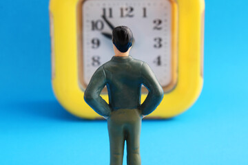 Businessman standing in front of a clock, task execution time