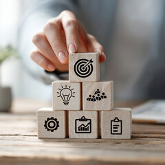 A person is stacking wooden blocks with a goal of reaching the top