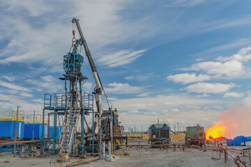 The Northern gas field. Summer. Installation for lowering a flexible pipe into a well. Equipment for testing and development of a gas well