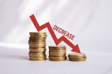 Red arrow with Decrease text pointing down with stacks of gold coins financial downturn