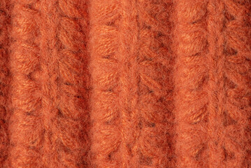 Knitted product made of brown wool as a background macro photo. Knitted background.