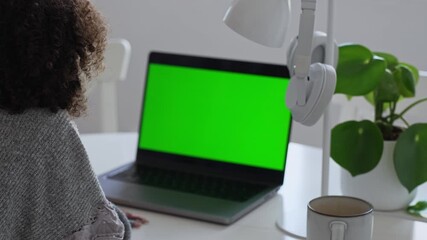 Primary school Student African American child with headphones using laptop green screen chroma key. Distance learning online education. Schoolboy girl studying at home with digital tablet computer and - Powered by Adobe