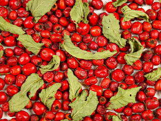 Dried plants and berries for medicinal teas and decoctions, mint and hawthorn. Natural background, top view.
