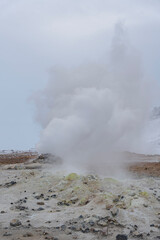 Ethereal scene of rising vapors amidst a rocky, otherworldly landscape.