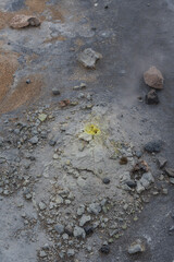A close-up shot of the sulfurous ground, with steam emerging from the earth.