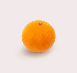 Orange isolated on white background. Single fresh orange on soft pink background with natural shadow
