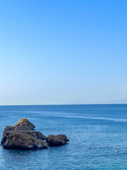 Solitary rock formation standing in calm blue Mediterranean Sea waters near Antalya coast, Turkey. High quality photograph