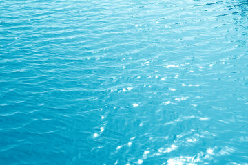 Turquoise rippled water texture background. Shining blue water ripple pool abstract 