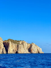 Natural sea cave arch carved into orange limestone cliffs by Mediterranean waves near Antalya, Turkey. High quality photograph