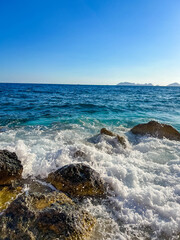 Mediterranean waves crashing over dark rocks along rugged coastline near Antalya, Turkey. High quality photograph