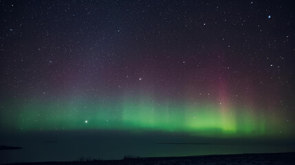 Spectacular display of green and purple Aurora Borealis illuminating the night sky over a dark horizon