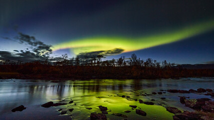Northern lights reflected in a lake in Abisko National Park