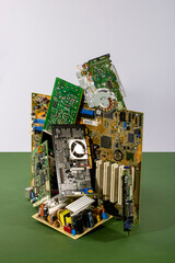 Abstract figure folded from computer circuit boards on a colored background