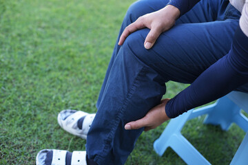 Man athlete gets pain after exercise and It happens often in athletes over practice. Sport and traumas concept and a jogger running and feeling acute pain in knee and ankle and massaging to get relief