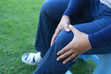 Man athlete gets pain after exercise and It happens often in athletes over practice. Sport and traumas concept and a jogger running and feeling acute pain in knee and ankle and massaging to get relief