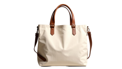 Cream tote bag with brown handles and strap, against dark backdrop, softly lit, plain and simple