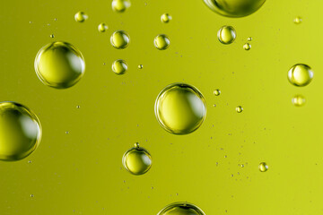 Droplets of liquid on a chartreuse green background  