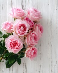 Bouquet of pink roses on a white wooden background from top view, elegant romantic and detailed with soft natural light.
