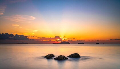 Sunset Over The Ocean With Rocky Outcrops And Distant Islands Under A Dramatic Sky