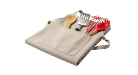 A beige apron with a pocket holding a wooden spoon, spatula, whisk, and pasta server tools