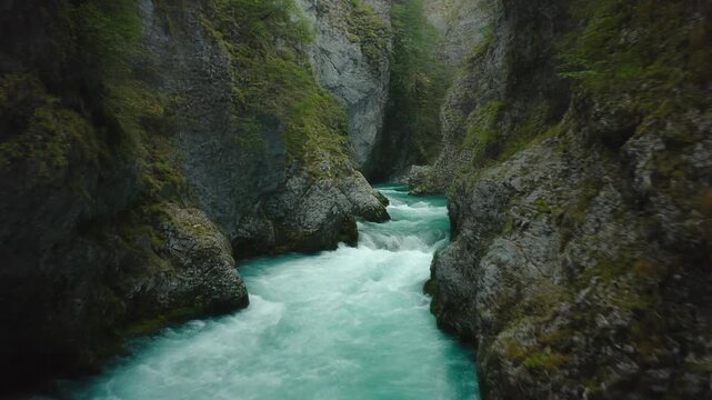 Turquoise River Carving Through a Lush Green Mountain Canyon with Rocky Cliffs