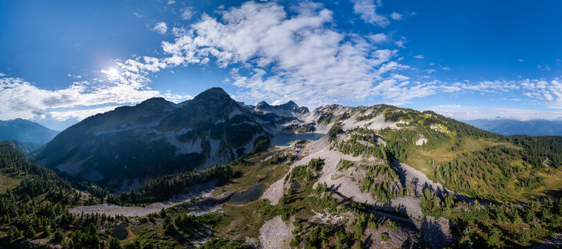 Panoramic Alpine Mountain Range With Glacial Lakes In British Columbia, Canada Under A Bright Blue Sky - Powered by Adobe