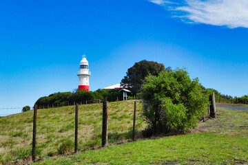 Low Head lighthouse, George Town in the Launceston region of Tasmania, Australia. Meadow and rural fence in the foreground

