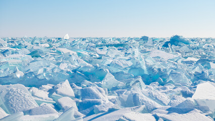 Transparent ice on Baikal lake at sunrise. Baikal, Siberia, Russia. Winter landscape