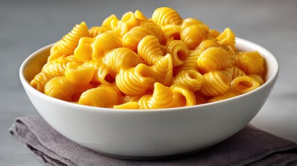 Delicious and creamy macaroni and cheese served in a white bowl on a dark napkin