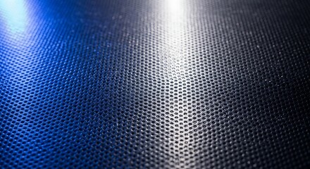 Futuristic background featuring a detailed close-up of a perforated metal grid surface reflecting dramatic blue and white spotlights