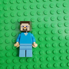 Naklejka premium Steve minifigure from Minecraft, a popular sandbox video game, depicted on a green LEGO baseplate
